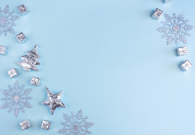 Snowflakes and gift boxes isolated on blue