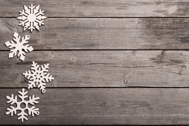 Snowflakes on grunge wooden background