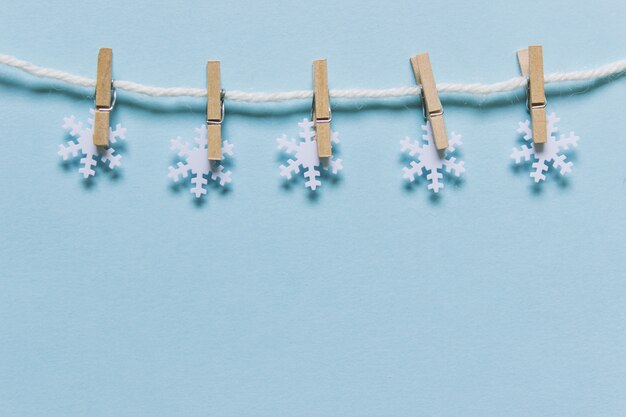 Snowflakes on a rope on blue backgound