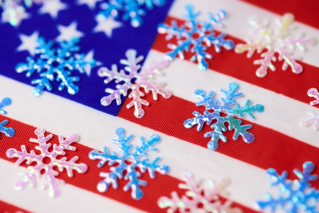 Snowflakes on USA flag. American winter. Weather forecast: snowfall or snow storm in United States of America.