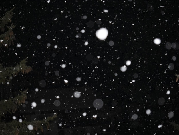 Snowing at night in dolomites mountains