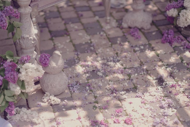 A snowman made of flowers sits on a tiled floor.