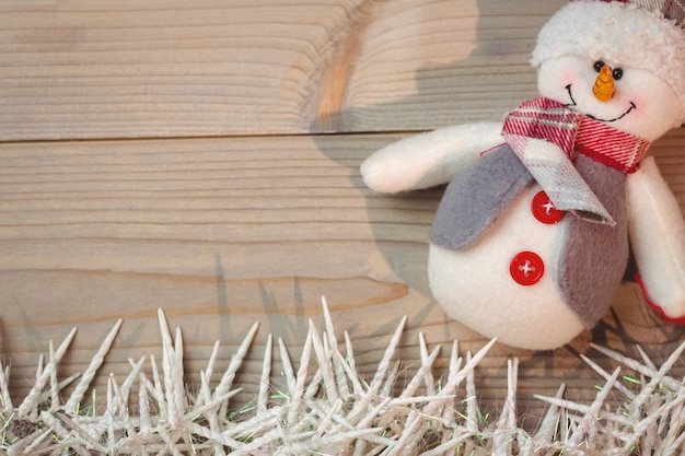 Snowman and small candles on wooden table