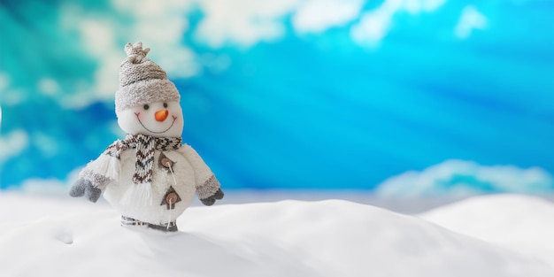 Snowman on snow blue sky and winter snowy background