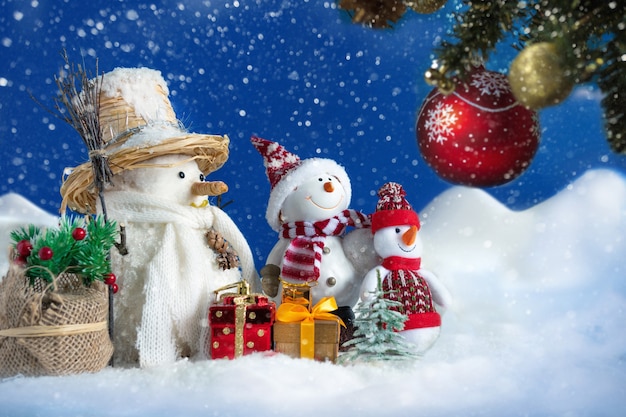 Snowman in a snowdrift with gifts and Christmas trees