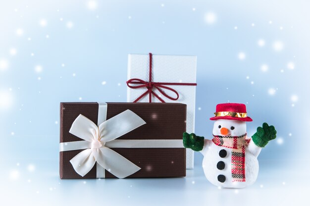 Snowman stand near gift box on white background, Merry Christmas and happy new year