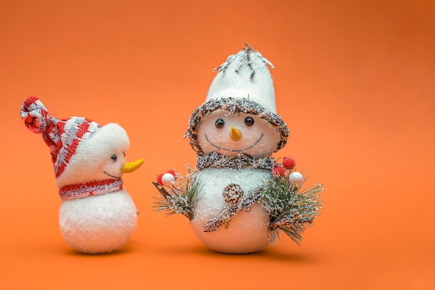 Snowmans isoalted on orange background