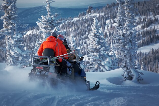 Snowmobile driving in the frozen forest