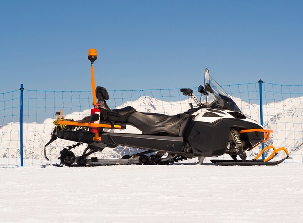 Snowmobile with rear rack box for alpine emergency rescue service.