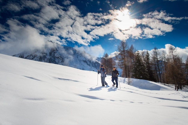 Snowshoes walk in the mountains of a couple