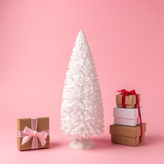 Snowy Christmas tree with gift boxes o