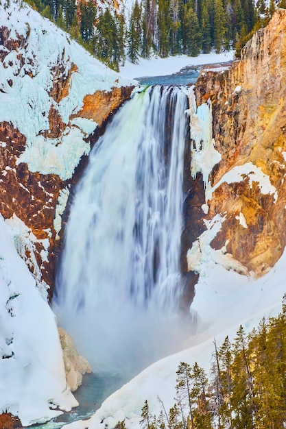 Snowy cliffs with Yellowstone Upper Falls