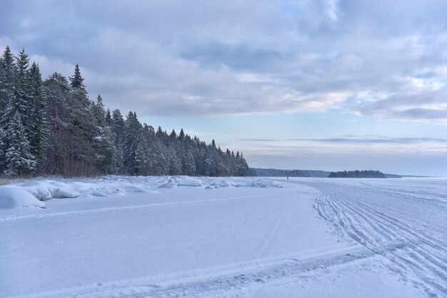 Snowy lake onega in winter and sky with clouds