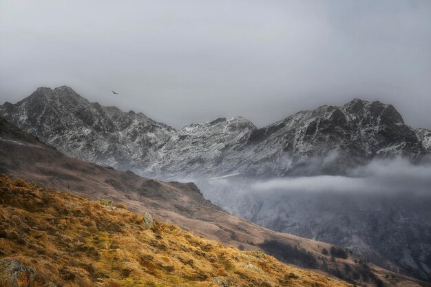 A snowy mountain landscape with a mountain in the background