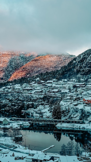 A snowy mountain landscape with a small town in the background