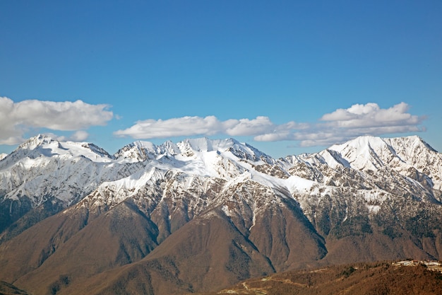 Snowy mountain peaks against the blue sky