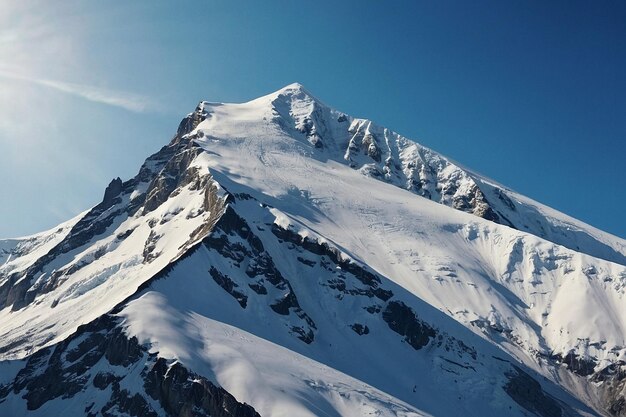 Snowy mountain peaks contrasting with a clear blue s