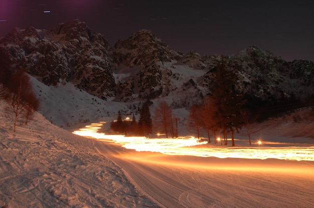 A snowy road with a light on it