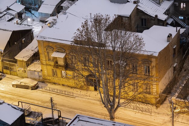 Snowy street in the night city