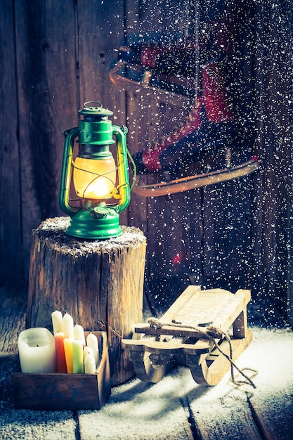 Snowy winter hut with snow and oil lamp