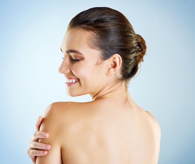 So beautiful she doesnt even have to try Studio shot of a beautiful young woman posing against a blue background