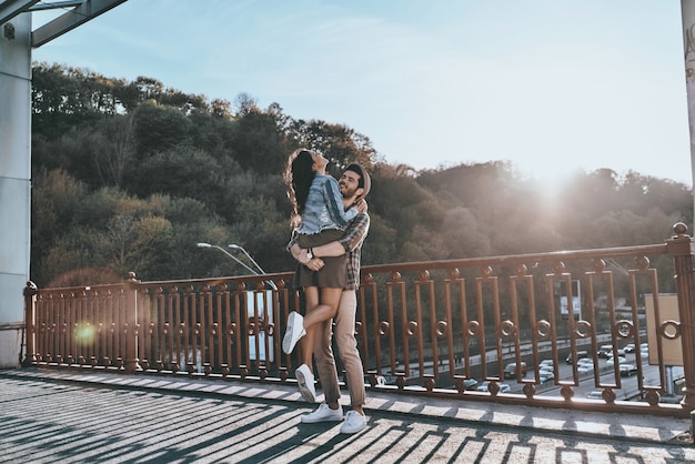 Photo so great to be in love! full length of handsome man carrying young attractive woman