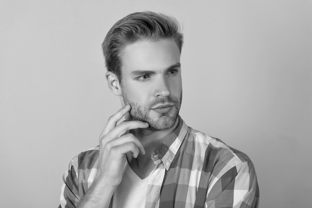 So serious Mans portrait yellow background Portrait of guy with straight face Handsome dude