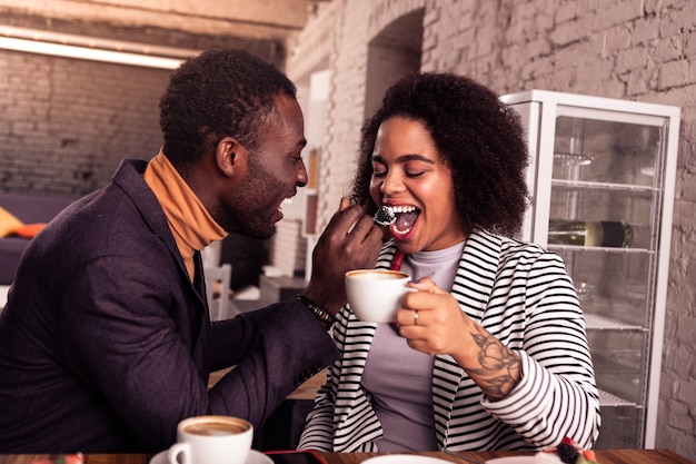 So tasty. Nice delighted woman opening her mouth while being fed by her boyfriend