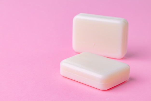 Photo soap bar isolated on pink background. close up.