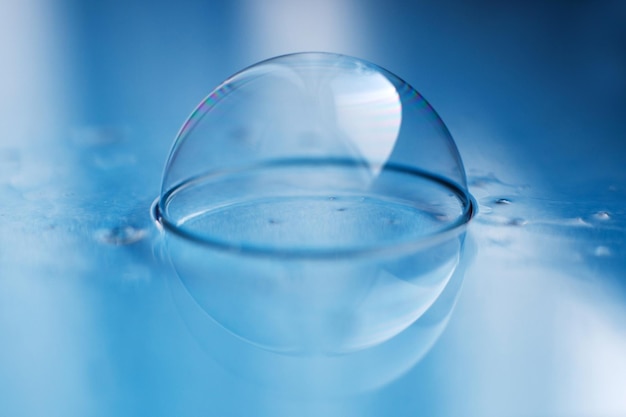 Soap bubble close up abstract blue water background