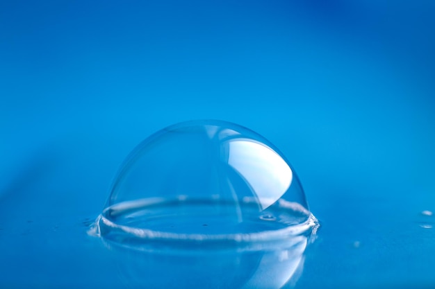 Soap bubble close up abstract blue water background