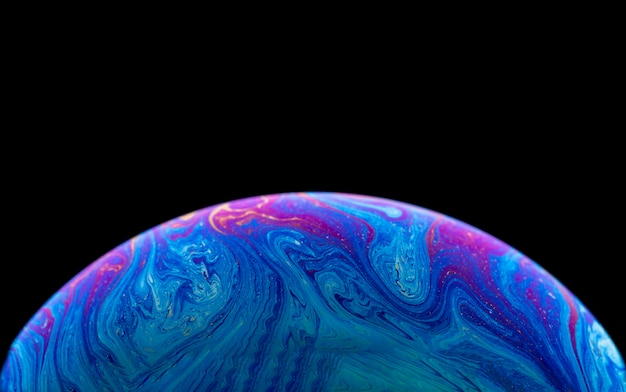 Soap bubble simulating the atmosphere of a planet with different shapes colors and a black backgrou