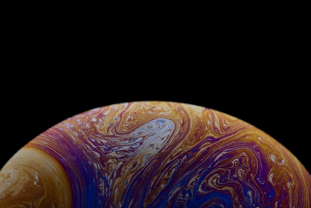 Soap bubble simulating the atmosphere of a planet with different shapes colors