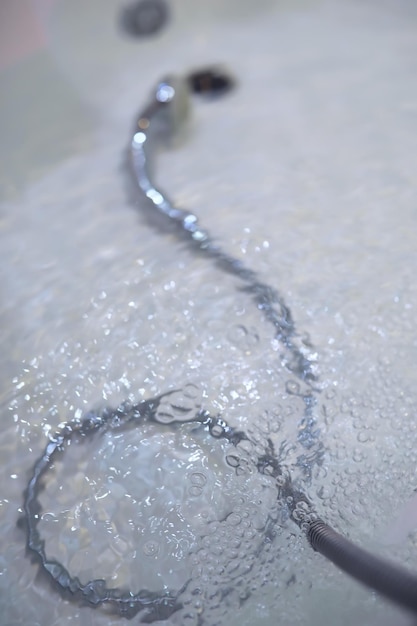 Soap bubbles background Shampoo foam in the water in the bathroom Jacuzzi elements