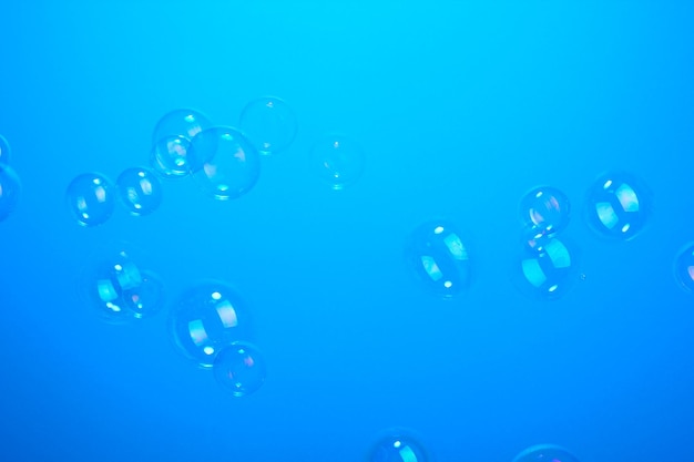Soap bubbles on blue background