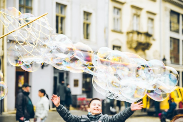 Soap bubbles in the center of old european city having fun