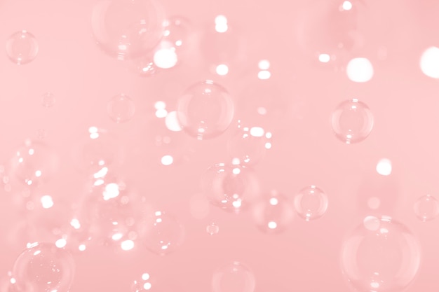 soap bubbles float on pink 