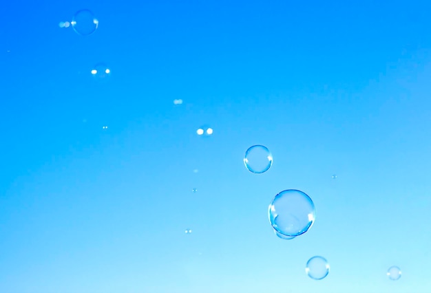 soap bubbles fly against the blue sky