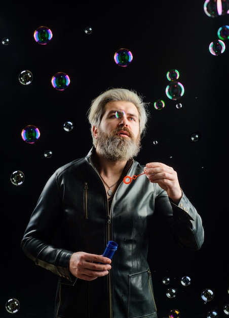 Soap bubbles man play with bubbles bearded man blowing soap bubbles happiness good mood childhood