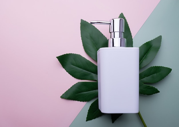 Soap dispenser on a green leaf