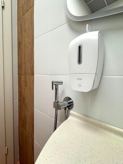 Photo soap dispenser in small public toilet