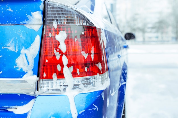 Photo soap foam drips down the glass. self-service car wash