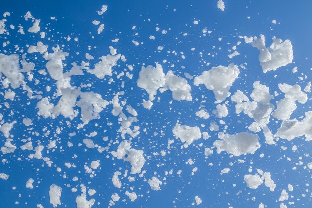 Soap foam flies from a cannon against the sky