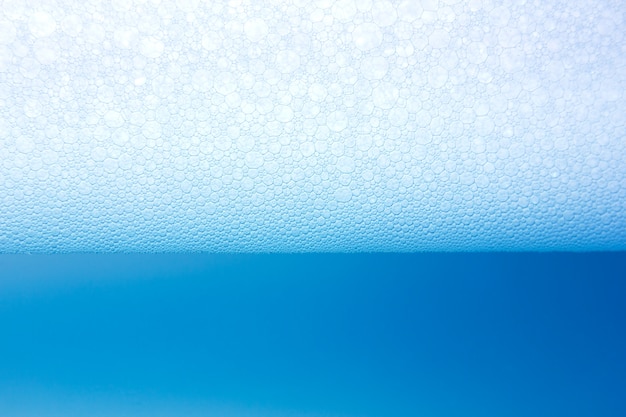 Soap foam on the water blue