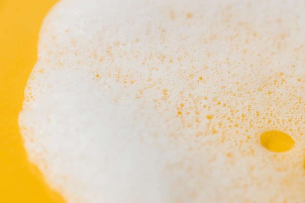 Soap foam on a yellow background