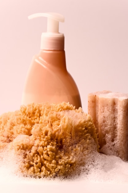 Soap, natural sponge and shower gel closeup