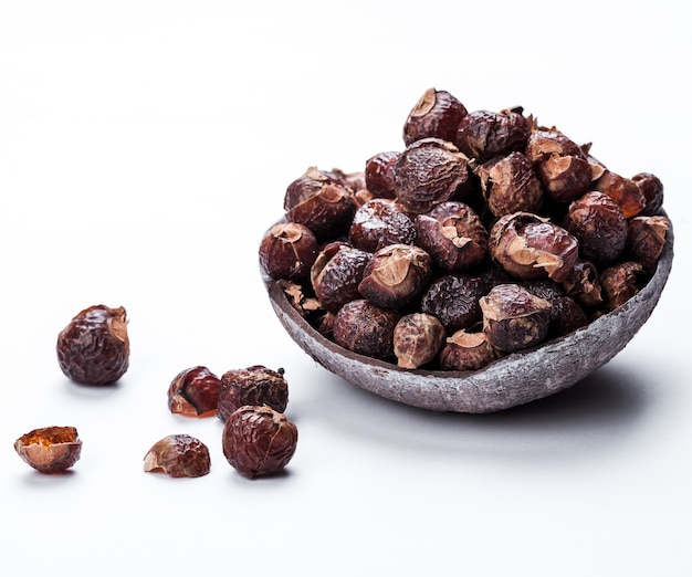 Soap nuts on a white surface in the coconut. Care products. natural, organic and