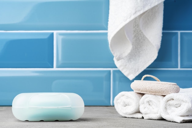 Soap and toiletries on shelf in blue bathroom