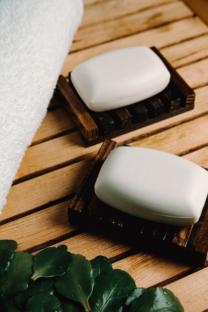 Soaps over a wooden soap dish in a bathroom with a spa concept relax