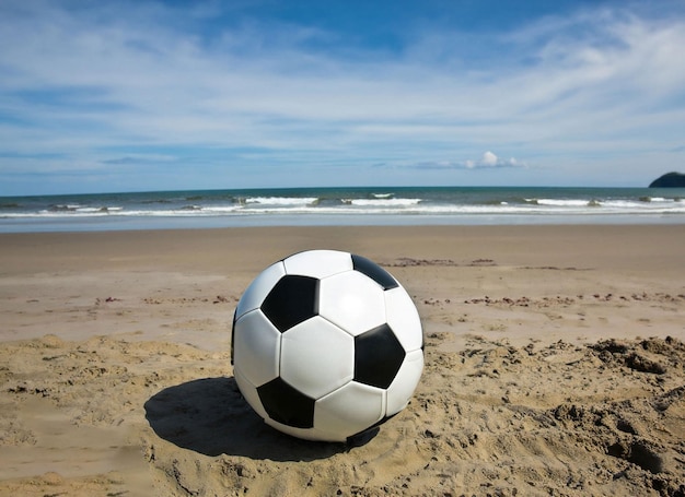 A soccer ball on a beach in the sand